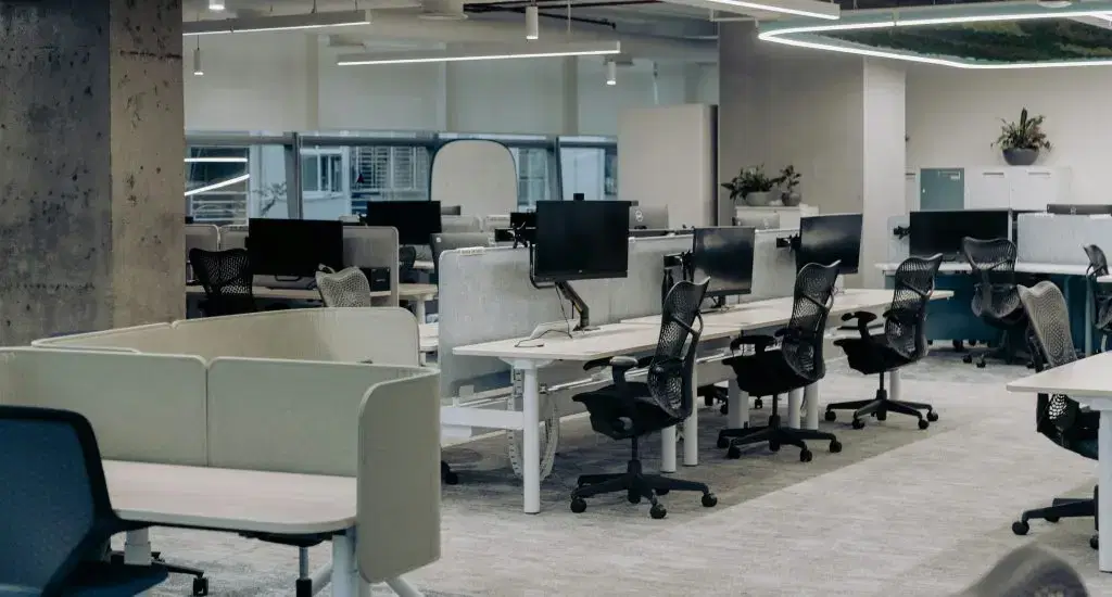 An empty office with desks and chairs in place.