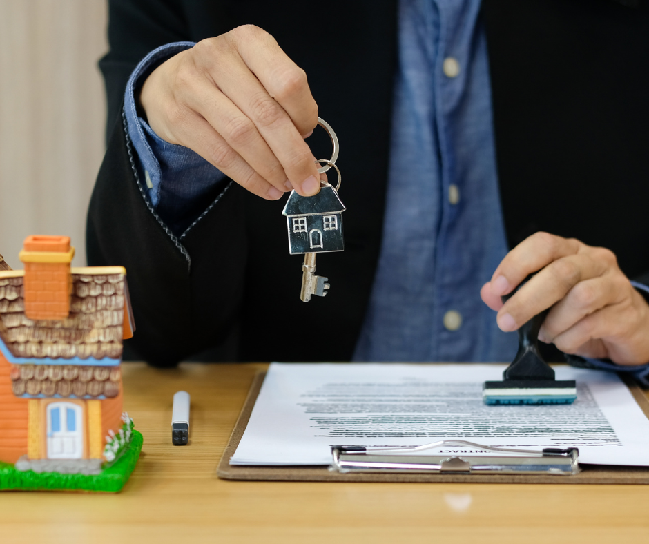 A bank manager handing the keys over to a property buyer with complex income. A loan approved stamp is also visible.